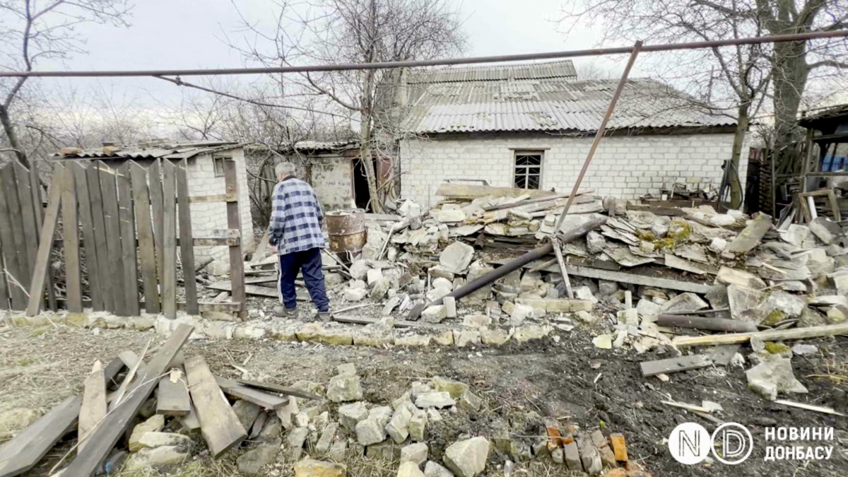 Житель Часов Яра Александр на фоне разрушенных обстрелом хозяйственных построек. Фото: Новости Донбасса